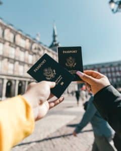 two people holding passports