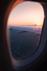 Airplane window with clouds